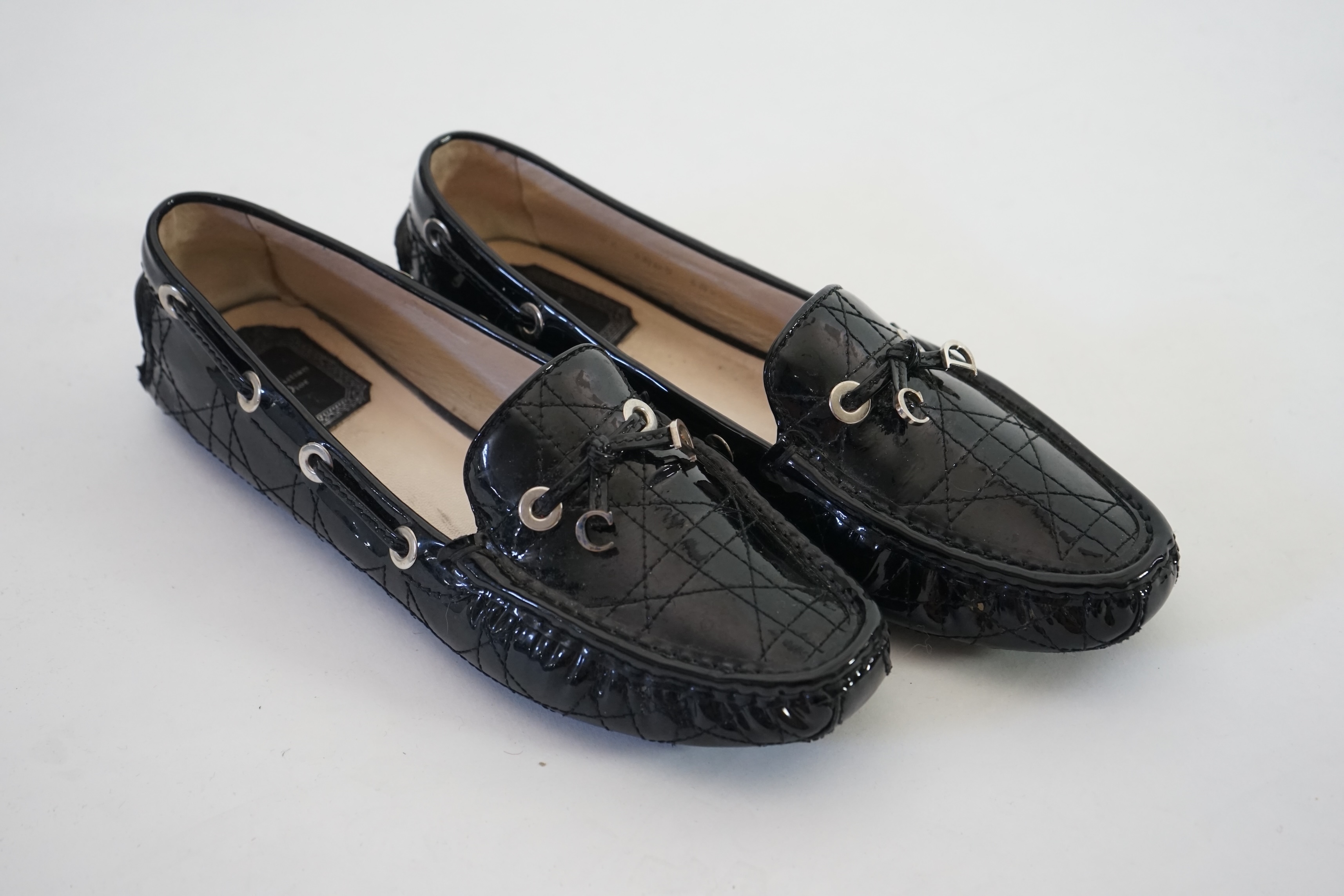 A pair of Christian Dior black patient leather lady's driving shoes with dustbag and in original box. Size 38.5. Proceeds to Happy Paws Puppy Rescue